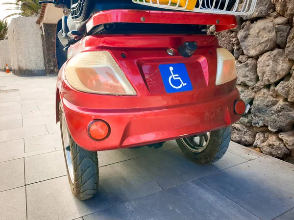 Closeup image of dasbled person sign on the electric wheelchair with three wheels — Stock Photo, Image