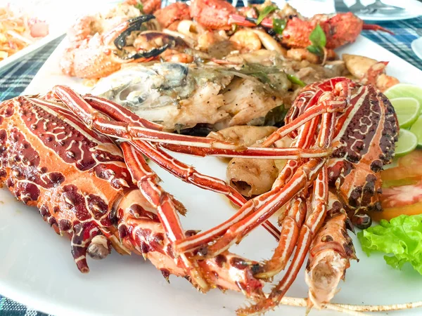Closeup photo of fresh cooked langoustines with vegetables on the dish at seafood restaurant — Stock Photo, Image