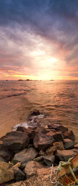 Beautiful panoramic photo of sunrise over the ocean and sharp cliffs on the beach — Stock Photo, Image