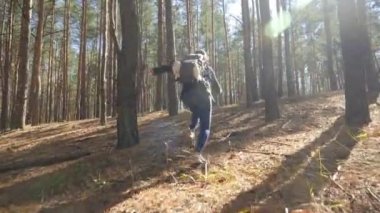 4k POV footage of maniac chasing after young woman with backpack running away in the forest