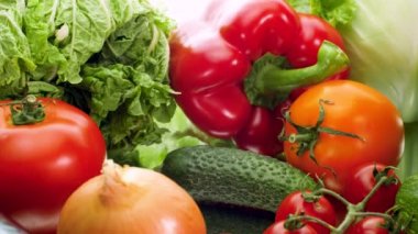4k dolly video of cucumber. tomato. cabbage. lettuce. eggplant. carrot and bellpepper on white background. Concept of healthy nutrition and organic food. Perfect shot for vegetarian or vegan