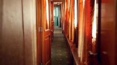 4k video of long hall in vintage retro train car with wooden doors and carpet on floor