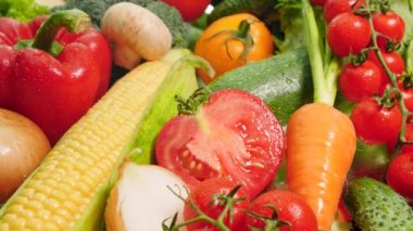 4k closeup dolly video of big heap of fresh and cut vegetables from farm. Concept of healthy nutrition and organic food. Perfect background for vegetarian or vegan