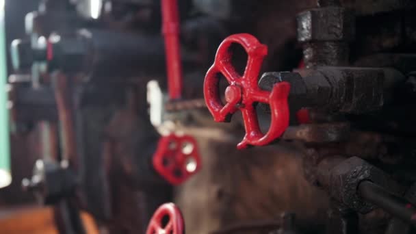4k closeup video of old valves and pipes painted in red in steam locomotive — ストック動画