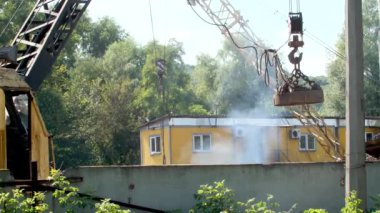 4k video of dark toxic smoke rising from metal scrapyard.