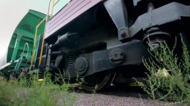 4k video of riding long cargo train with big train cars used for coal transportration. Concept of transportation and cargo using railways
