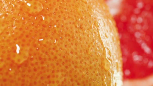 Movimiento lento de gotas de agua cayendo y rodando de cáscara de naranja fresca madura. Perfecto tiro abstracto para alimentos orgánicos y una nutrición saludable. Primer plano de los cítricos — Vídeos de Stock