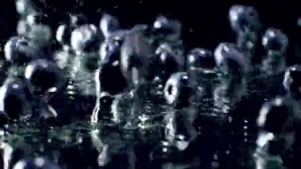 Slow motion macro footage of blueberries falling on wet black surface. Perfect abstract backdrop for organic food and healthy nutrition. Closeup of fruits and berries — Stock Video