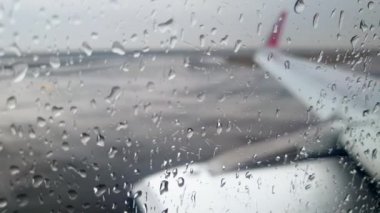 4k video of unstable vibrating airplane driving on wet ariport runway during rain storm