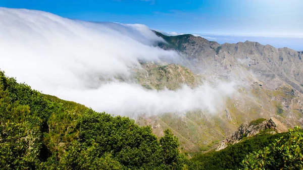 Paisagem de nuvens voando sobre o vale da montanha em dia ensolarado brilhante — Fotografia de Stock
