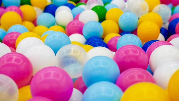 Primo piano foto astratta di palla di plastica colorata nella fossa sul parco giochi al centro commerciale — Foto Stock