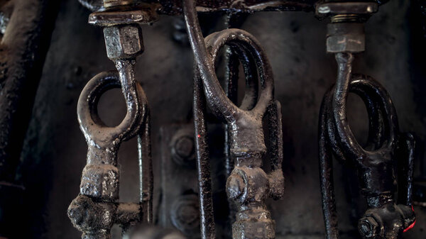 Macro image of black old pipes and vavles at steam engine
