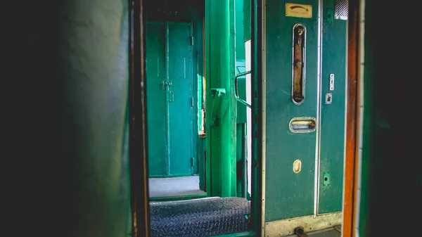 Toned image of open doors in corridor of vintage steam express trian — Stock Photo, Image