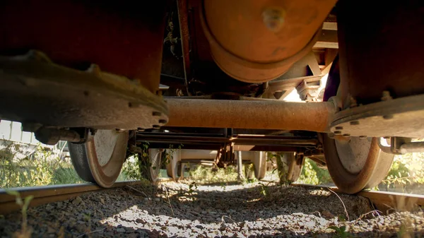 Вид с земли на старый ржавый грузовой поезд на железной дороге — стоковое фото