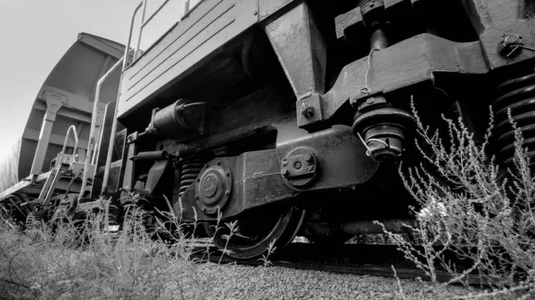 Black and white image of big cargo train cars on industrial railroad — Stock Photo, Image