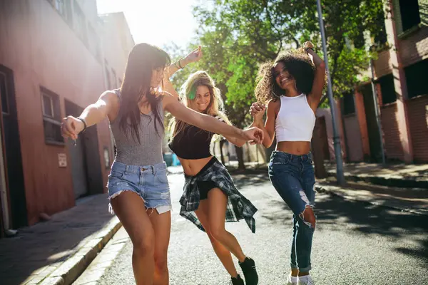 Mujeres jóvenes divirtiéndose en la calle de la ciudad — Foto de Stock