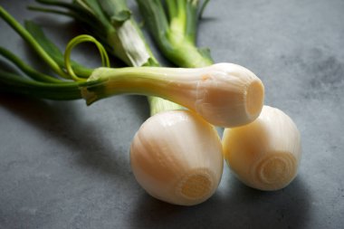 Gri bir masada soğanlar.