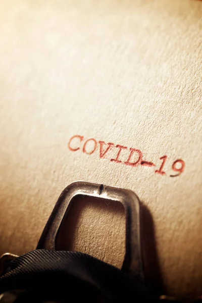 Covid-19 word written on a paper.