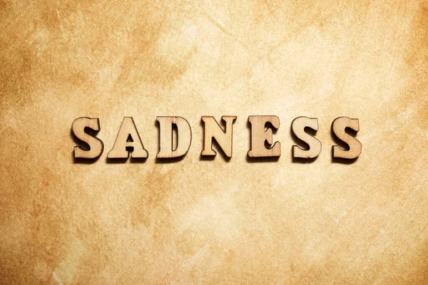 Sadness Word Brown Paper — Stock Photo, Image