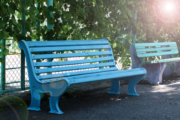 Banco azul, banco ao sol, lugar no parque, banco de madeira, esvaziar o banco — Fotografia de Stock