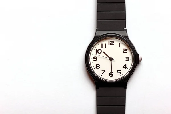 Relógio de pulso preto e branco uni-sexual clássico no fundo — Fotografia de Stock