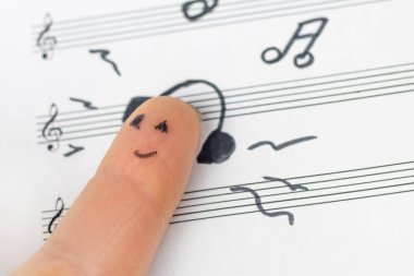konsept. Parmak notalara uzanır ve müzik dinler. Tatmin oldu..