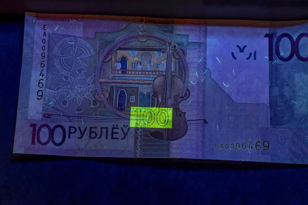 Bankovka o velikosti 100 rublů. se nachází v ultrafialové lampě — Stock fotografie