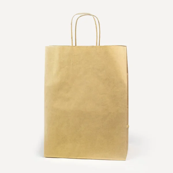 Gray paper bag on a white background. concept of rejection of plastic bags. close-up. — Stock Photo, Image