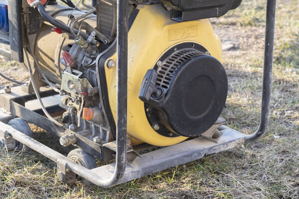 close-up. Street lighting. A gasoline-powered generator that produces current. Backup or emergency power source. The generator is not new