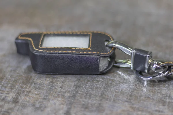 Car alarm cover. Made of leather and stitched with threads there is a ring to hang with keys — Stock Photo, Image