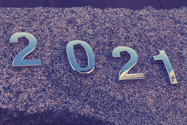 2021 year figures made of metal. Laid out on the stone. Shallow depth of field. There is a tint — 스톡 사진