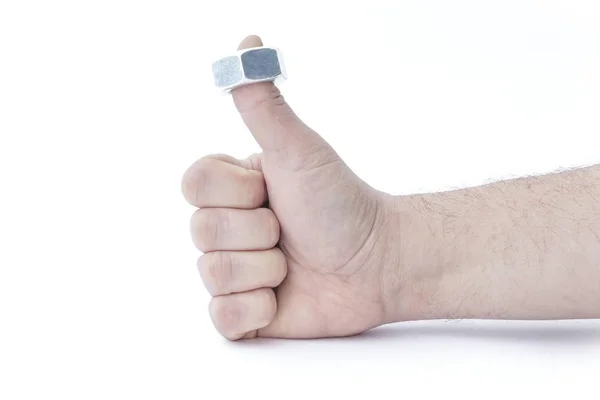 Male hand. A nut is dressed on a thumb, it is lifted up. Build concepts of a quality construction tool — Stock Photo, Image