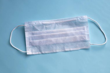 medical mask for protection against bacteria. On a blue background. Close-up