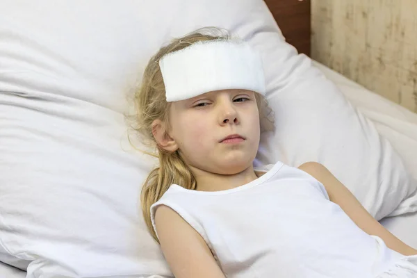 Girl White Hair Lies Bed She Has Bandage Her Forehead — Stock Photo, Image