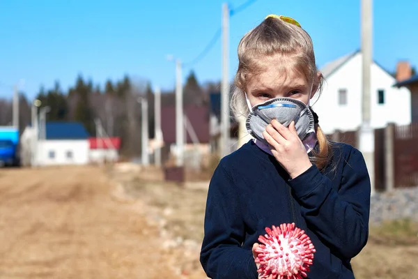 A child with white hair in a dark sweater and medical mask. Prohibition of school attendance. insulation