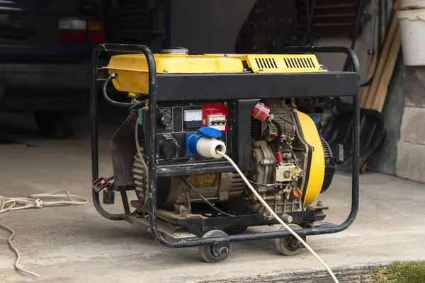 stand-alone diesel generator to supply electricity in an emergency. Yellow color. Serves not a large residential building.