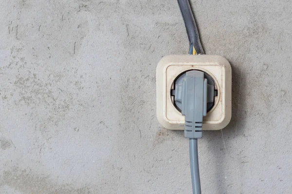 Electric sockets light works mounting and installation on plaster wall background. Professional installation of electrical outlets, wires and switches. Close up side view