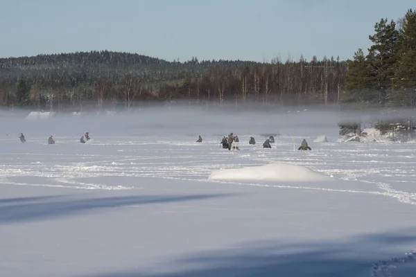 people icefishing on a lake in sweden