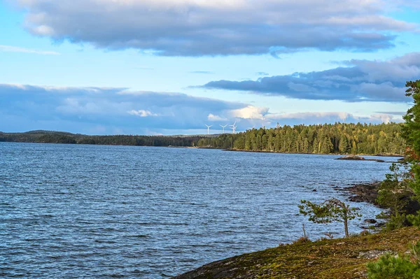 Windmills in forest behind lake Vattern Sweden — ストック写真