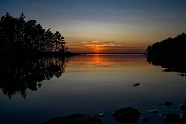 Orange sunset over a calm lake in Sweden — Stock Photo, Image