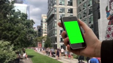 Manhattan, New York 'taki High Line Park' ta Akıllı Telefon Yeşil Ekran Erkek Eli Tutuşu. Yeşil ekranı istediğin görüntüyle ya da resimle değiştirebilirsin. Anahtar efektiyle yapabilirsin..