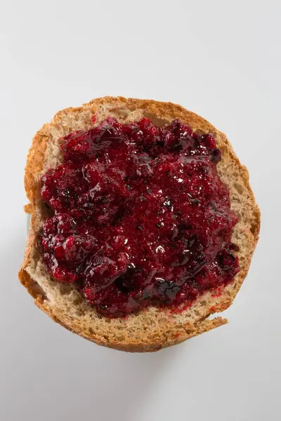 Roasted bread with layer of black currant jam — Stock Photo, Image