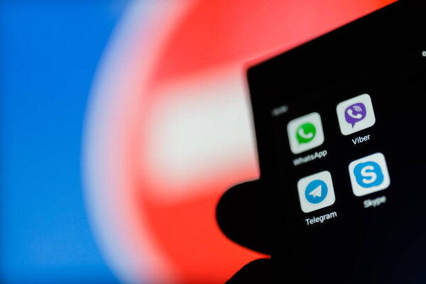 МОСКВА, РОССИЯ - 16 апреля 2018 года: Мобильный телефон с популярными мессенджерами в руке против запрещающего знака. В России спецслужбы требуют от создателей мгновенных мессенджеров предоставления ключей расшифровки для контроля корреспонденции пользователей
.