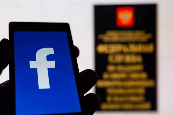 Moskova, Rusya - 9 Mayıs 2018: Smartphone popüler sosyal ağ Facebook logolu elinde. Roskomnadzor (Rkn) ofis girişi. Genel veri koruma Yönetmeliği (Gdpr) kavramı. Sansür