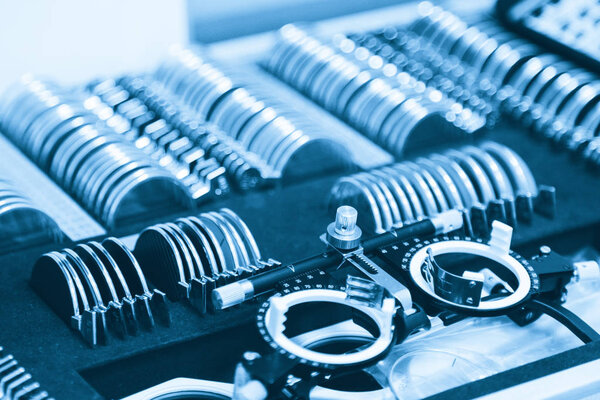 A set of replaceable lenses and a special universal trial ophthalmic setting for optometry and eyeglasses. Diagnostic equipment set. The doctor's office in the optical store. Pharmacy. Eye clinic