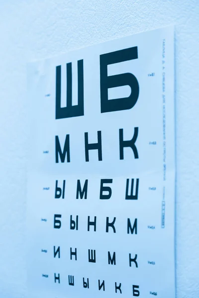Ophthalmic chart for checking visual acuity. Russian letters or soviet version. USSR. Doctor's office. Optics store. Cold toned bw (black and white) version — Stock Photo, Image
