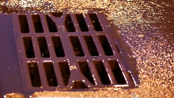 Drain metal grill on the road during the rain. Pig-iron rusty iron hatch plate — Stock Video