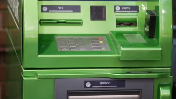 Green ATM of Sberbank. The bar above the card slot flashes — Stock Video