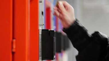 The passenger drops coins and banknotes into the bill acceptor