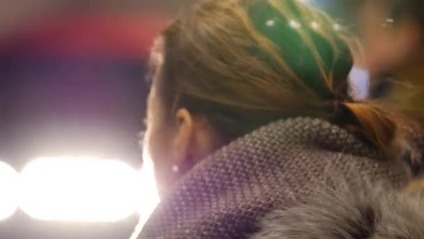 Young pretty girl looking away stands on subway platform during arrival of train — Stock Video